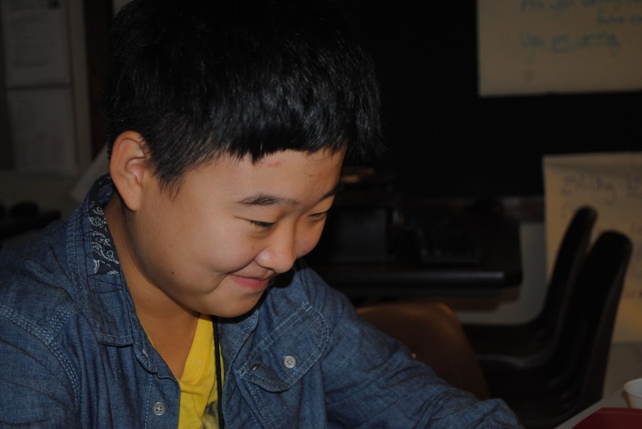 Zhiling Guan, senior, sits in Cox’s classroom doing an activity where she reads aloud along with her classmates to practice their pronunication. Guan and the other students went around in a circle, reading a comic book styled novel about a group of travelling children who encountered a strange town.