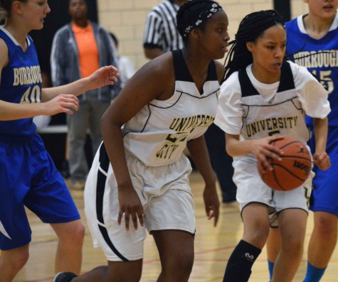 In the second half, Diamonique Dunn, freshman, drives to the basket with Kylaa Anderson, freshman, trailing the play.  PHOTO BY DELLA COX