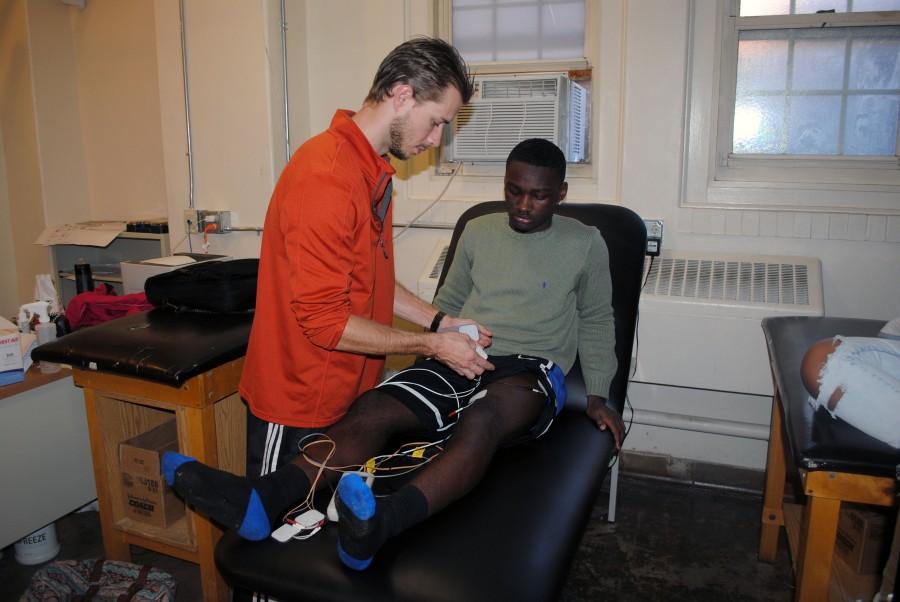 Ryan Weilandich treats freshman Cashawn Beckum with the STEM machine to help him recover from a minor torn ACL. “Ryan helped me recover from a minor injury in the fastest and effective way possible, which took about 3 weeks,” said Beckum. PHOTO BY PABLO LOPEZ