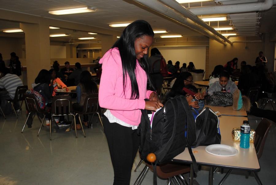 Rifling through her backpack during lunch, La’She Tomlin-Wilks, senior, rearranges her belongings. “I like to be organized, so I have binders for each class,” said Tomlin. “‘A’ days are the worst, because I have four core classes, so I have to carry four binders.” PHOTO BY JACELYNN ALLEN