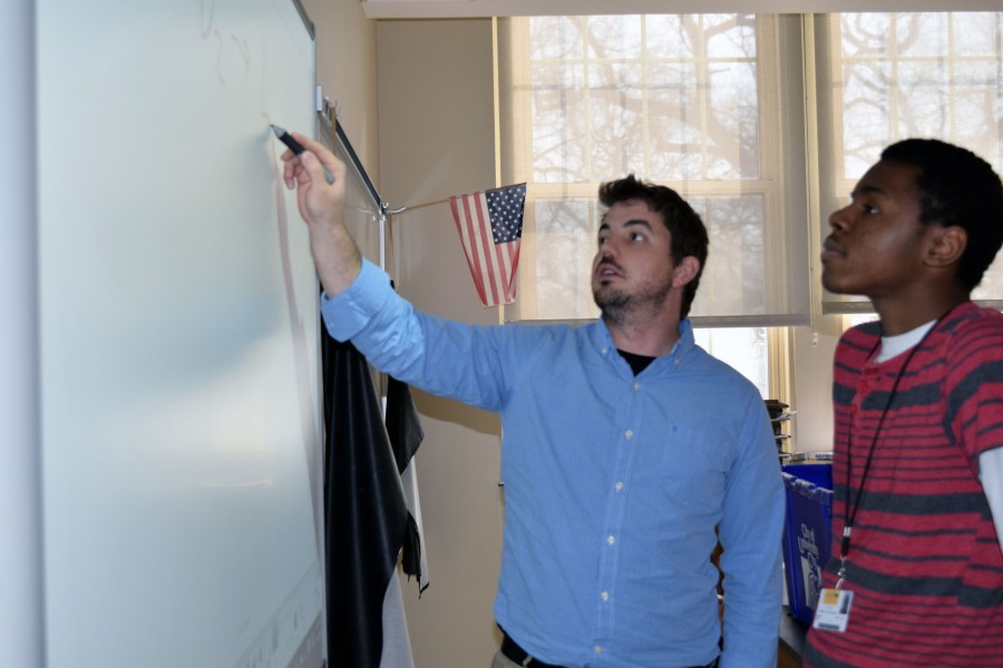 Ryan Allen receives extra help from Rollins for his upcoming chemistry test the next period. I want the students to learn chemistry so I try to make myself available during seminar, said Rollins. 