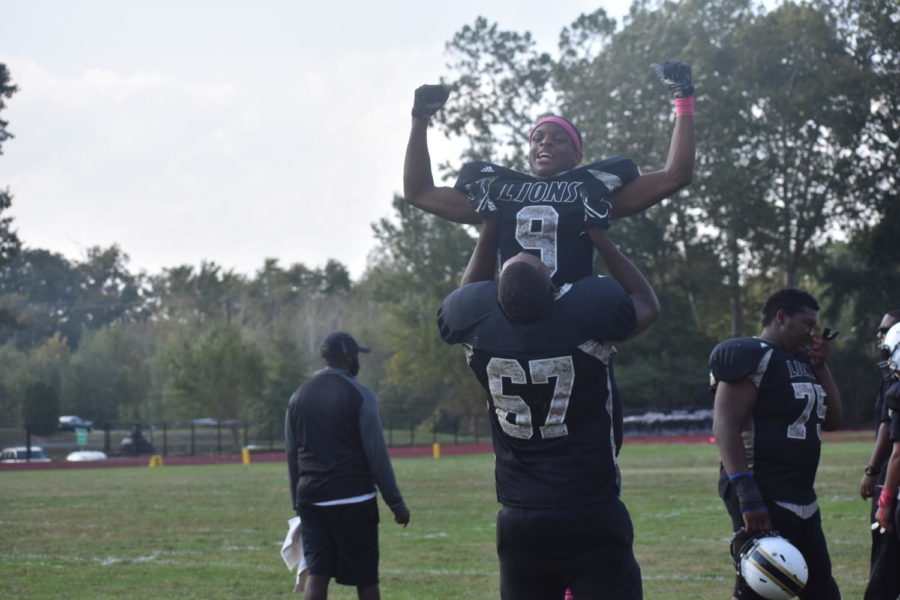 Football players celebrate after homecoming win