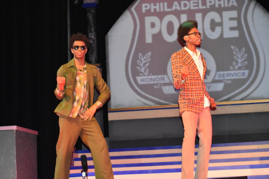 Senior William Austin (left) and junior Marquess Pearson (right) dance along to the beat during the spring musical "Sister Act" 