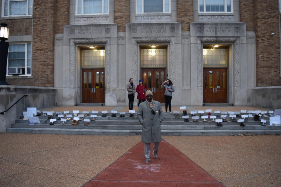 Getting to school at 6 am to set up the display of shoes, Rowan Hoel and Leah Zukosky, seniors, along with Michael Peoples, principal, prepare for students to arrive. It took about two and a half hours [to set up], Hoel said. We started the day before, taping shoes. First we had to get all the shoes which took a week. For each name, we cut out a piece of poster board and wrote their name and age on it.