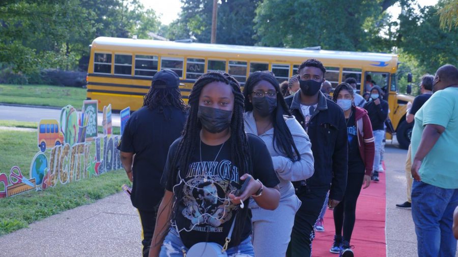 Students arrive to walk the red carpet into their first day of school 