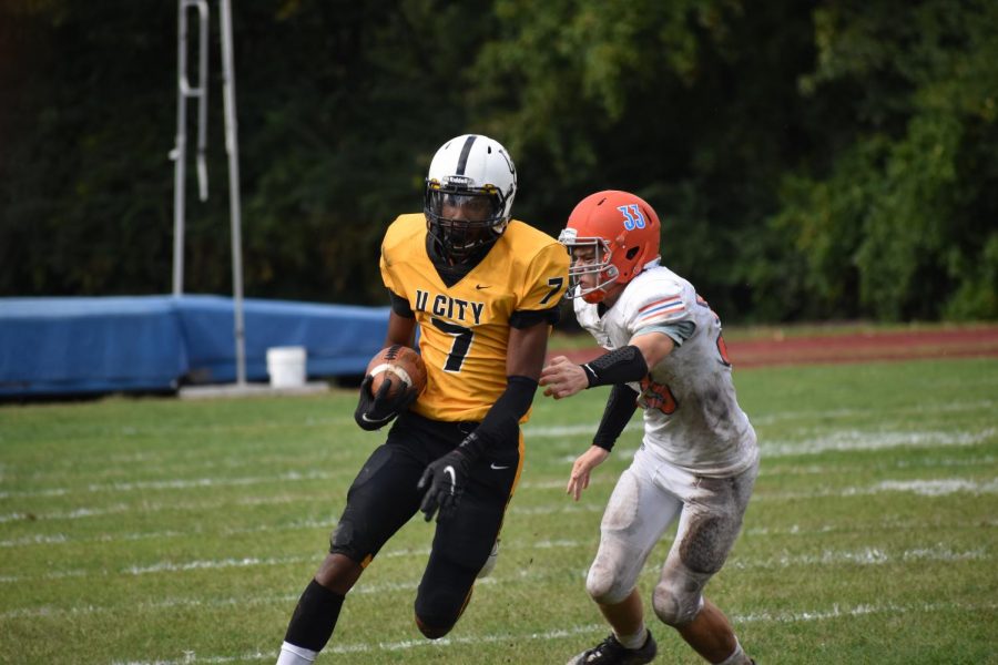 To keep the lead, Carleton Thomas, senior, tires to outrun Clayton defense.  We played as a team and didnt bring our teammates down when they made mistakes, Thomas said. 