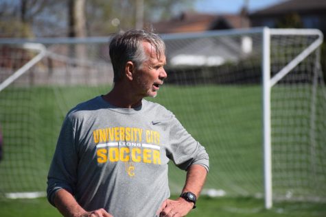 Before the girls game against Ritenour, Thomas Henson, coach, directs the players in warm-ups. The Lions won the game 3-1.