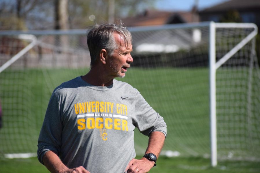 Before the girls game against Ritenour, Thomas Henson, coach, directs the players in warm-ups. The Lions won the game 3-1.