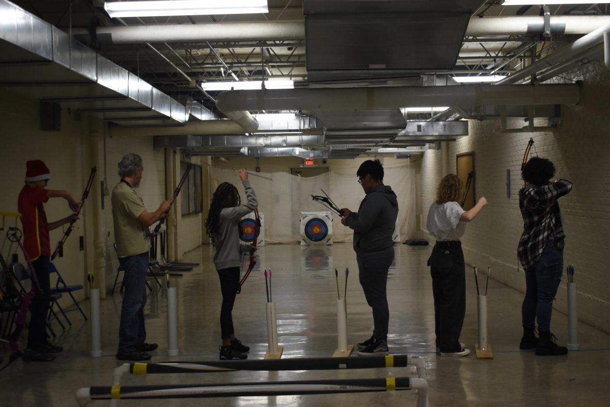 Dan Holden, head coach lines up with the players to practice shooting. I was knocking the arrow on the bow, which is just putting it on there so I can get ready to shoot the target, Emily Blackwell, junior, said.